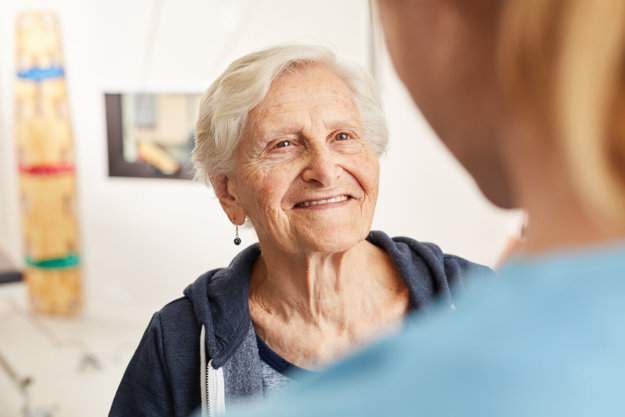 senior woman talking to nurse at assisted living for seniors