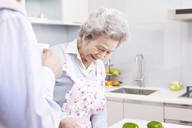 senior woman cooking in kitchen at Independent Living for Seniors