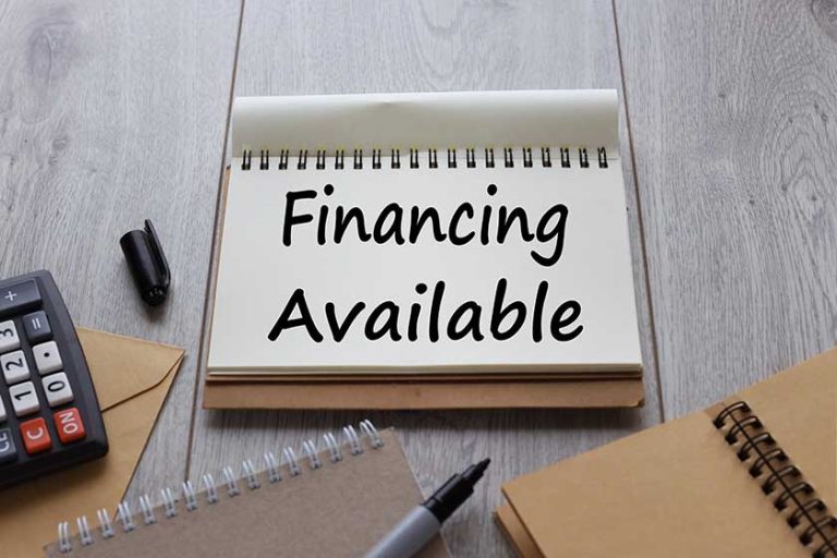 Financing Available text on notepad paper near many notepads Financing Available text on notepad paper near many notepads
