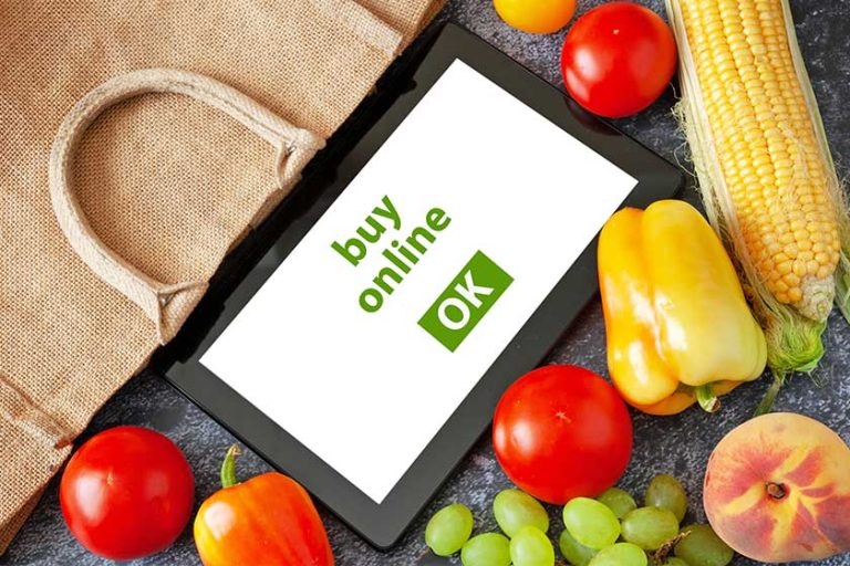 Organic Vegetables and fruits in cotton bag and tablet pc Organic Vegetables and fruits in cotton bag and tablet pc