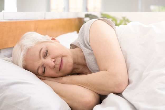 Senior woman sleeping in bed in morning Senior woman sleeping in bed in morning
