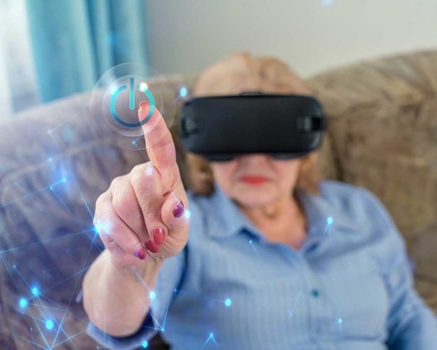 Amazed senior woman enjoying cyber world, using VR glasses at home. New trends and technology concept and funny active elderly Amazed senior woman enjoying cyber world, using VR glasses at home.