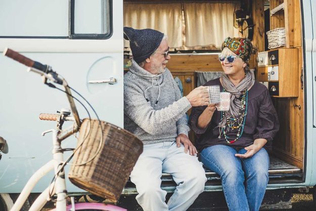 Happy cheerful mature people couple caucasian traceler enjoy and Happy cheerful mature people couple caucasian traceler enjoy and take a break resting sit down out of her van