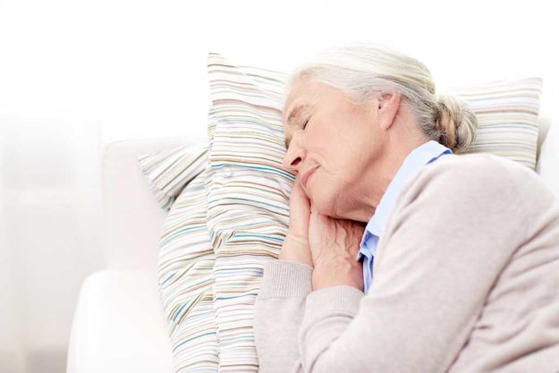 happy senior woman sleeping on pillow at home happy senior woman sleeping on pillow at home