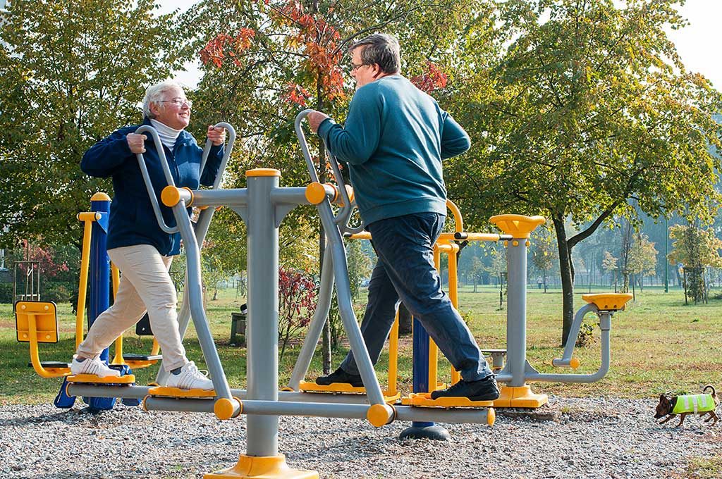 Senior couple doing exercise outdoors