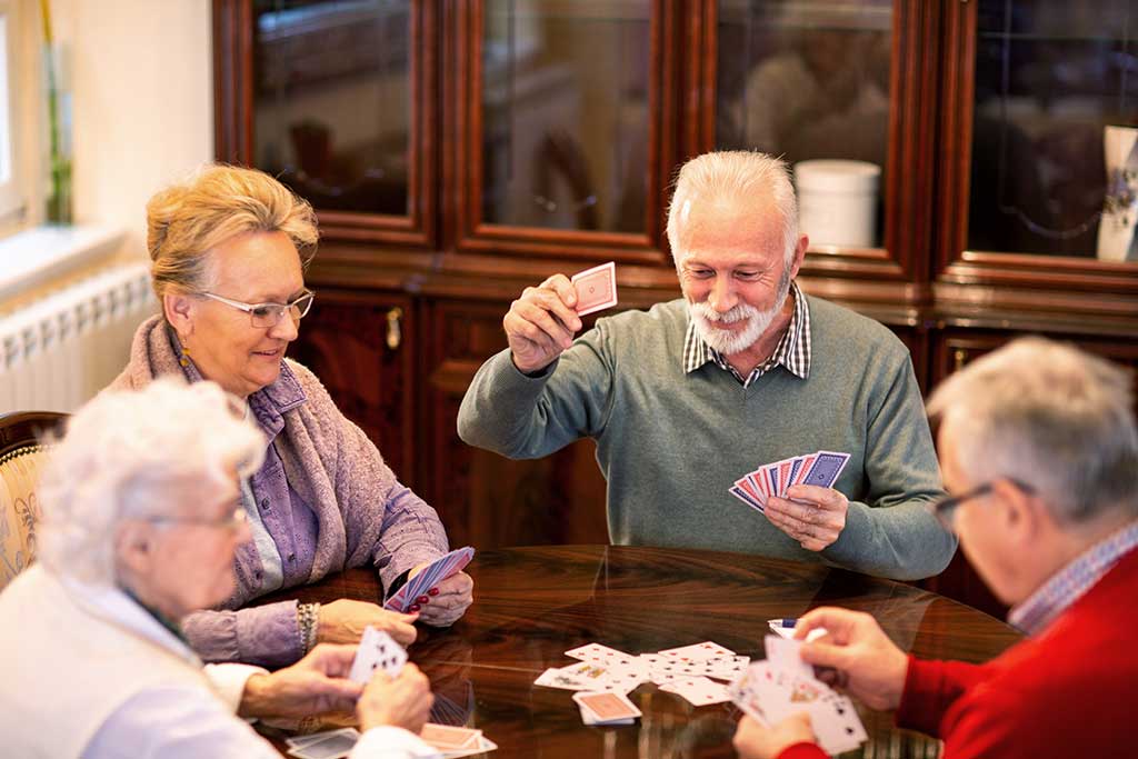 Senior people playing card games Senior people playing card games and having fun in doing so