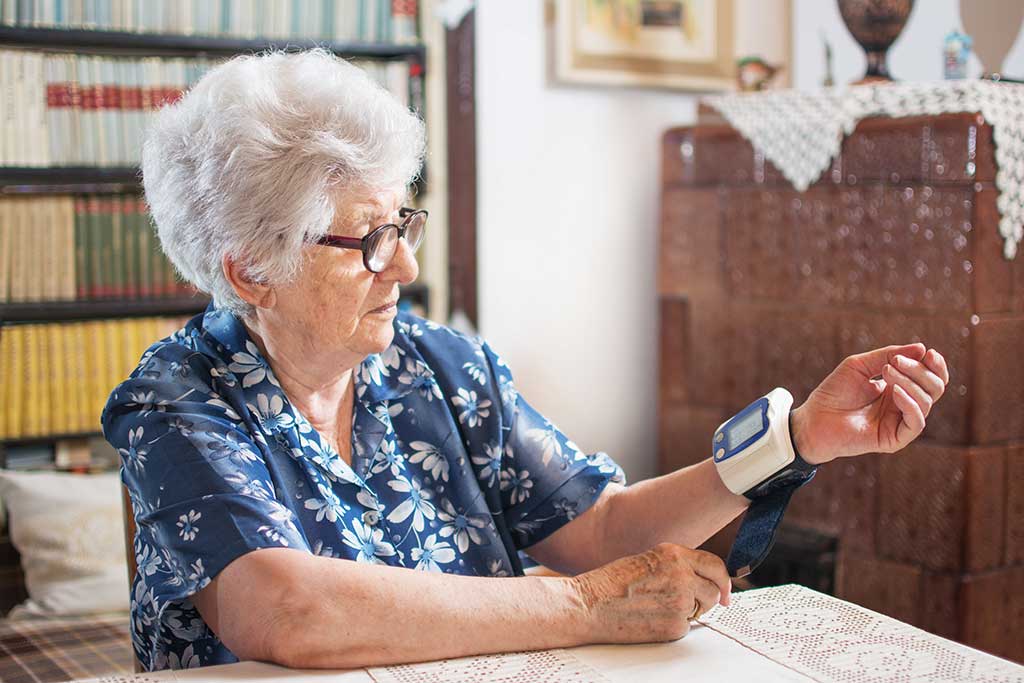 Old Senior Lady Using Pressure Measuring Apparatus Measure Her