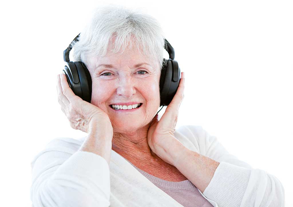 Smiling senior woman listening music with headphones Smiling senior woman listening music with headphones
