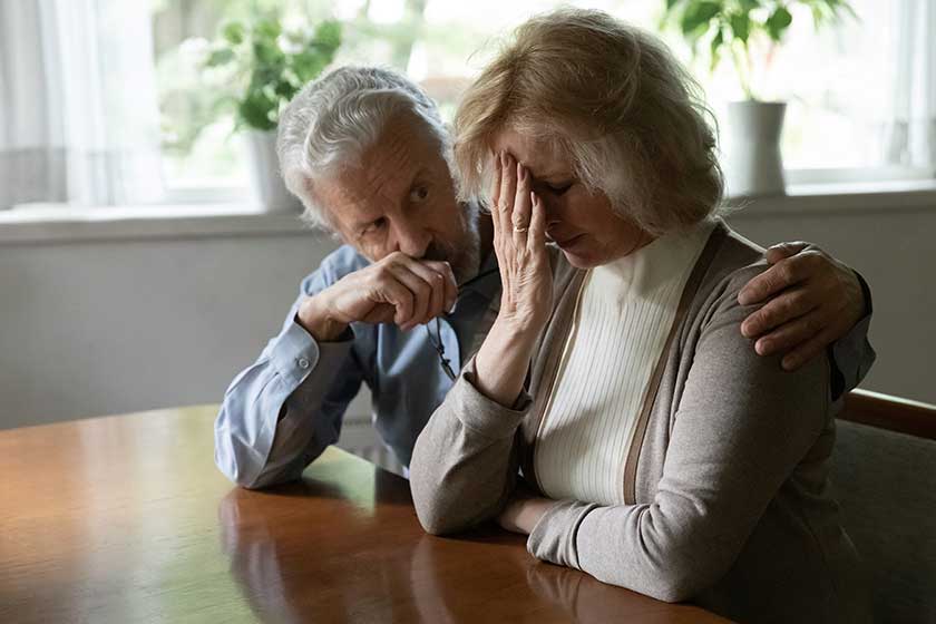 Upset middle aged family couple grieving, getting bad news about health problem