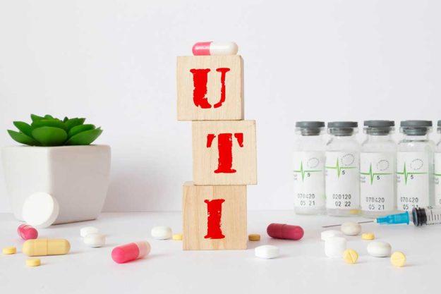 UTI – acronym from wooden blocks with letters, abbreviation UTI urinary tract infection. UTI - acronym from wooden blocks with letters, abbreviation UTI
