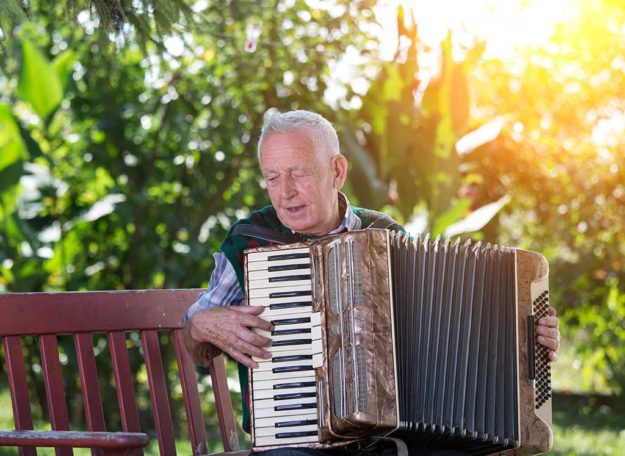 Senior man playing accordion Senior man playing accordion