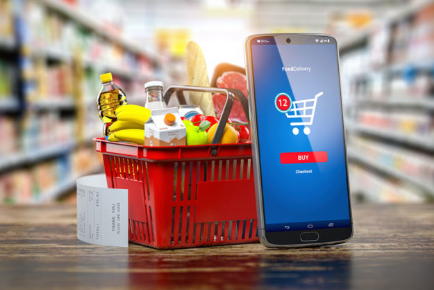 Shopping basket with fresh food and smartphone. Shopping basket with fresh food and smartphone.