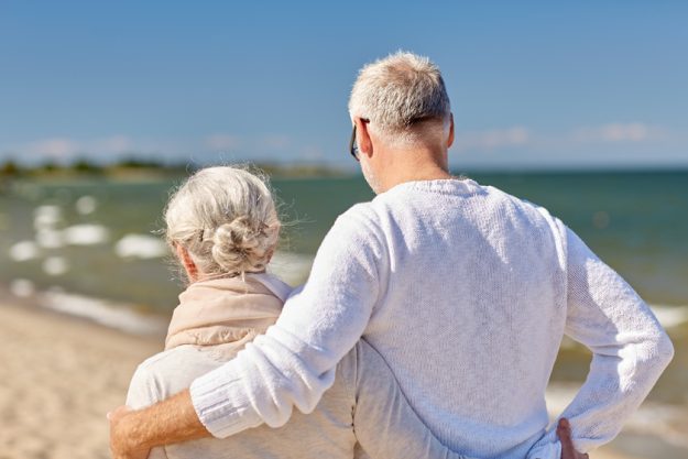 happy senior couple hugging on summer beach happy senior couple hugging on summer beach