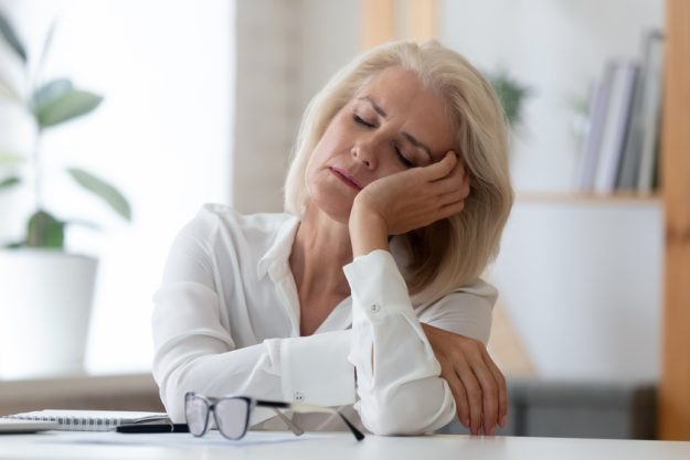Exhausted senior businesswoman fall asleep at workplace Exhausted senior businesswoman fall asleep at workplace