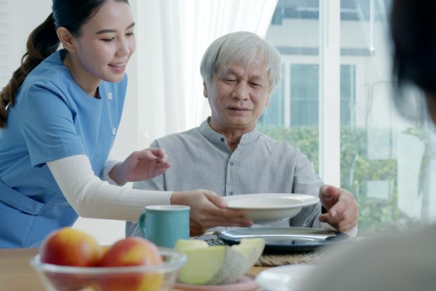 Attractive young senior asian citizen couple happy sit, talk, ea Attractive young senior asian citizen couple happy sit, talk, ea