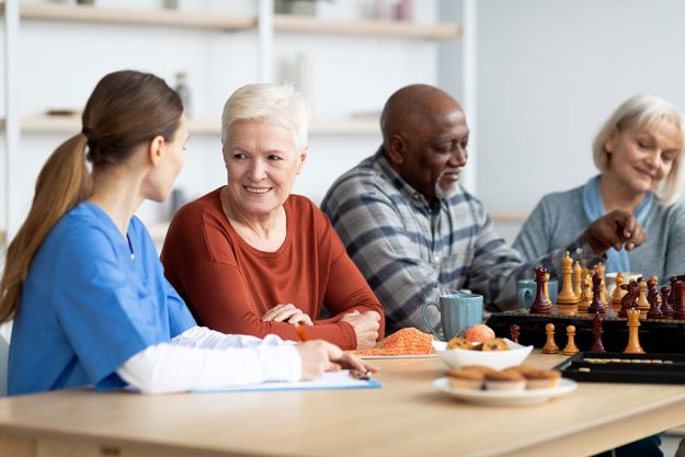 nurse-having-conversation-with-attractive-senior-woman Nurse having conversation with attractive senior woman
