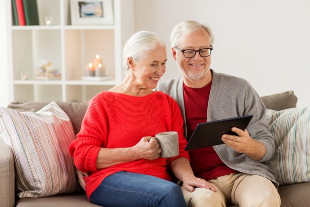 happy senior couple with tablet pc at christmas 4 Reasons To Move To Senior Apartments In Jacksonville, FL