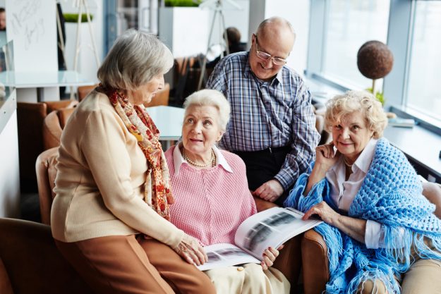 Gathering of senior friends Enjoying The Benefits Of 55+ Communities In Jacksonville, FL
