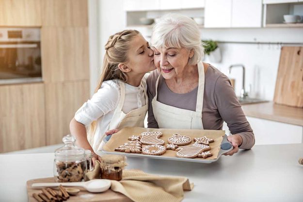 Happy child thanking grandma for sweet pastry Happy child thanking grandma for sweet pastry