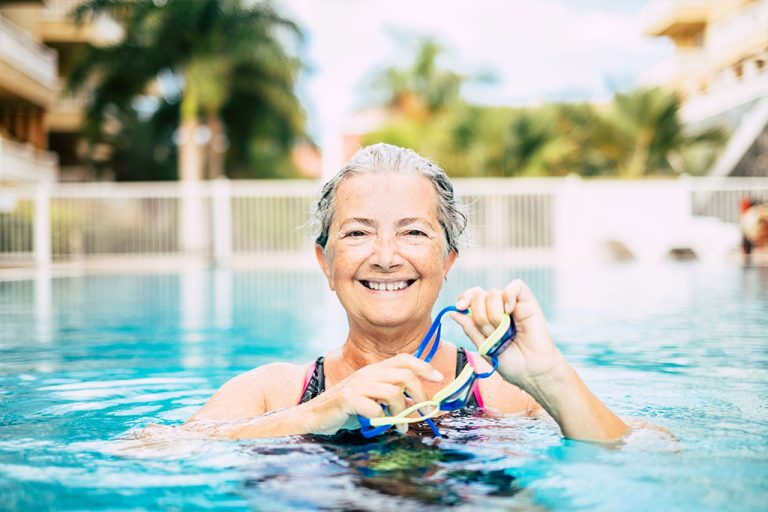 one mature woman doing activity at the pool swimming and training alone