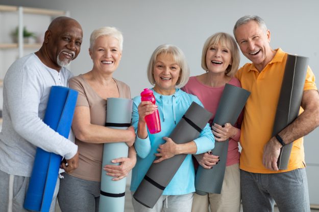 Group of athletic pensioneers attending yoga class at retreat center Senior Centers In Jacksonville, FL: What Do They Offer?