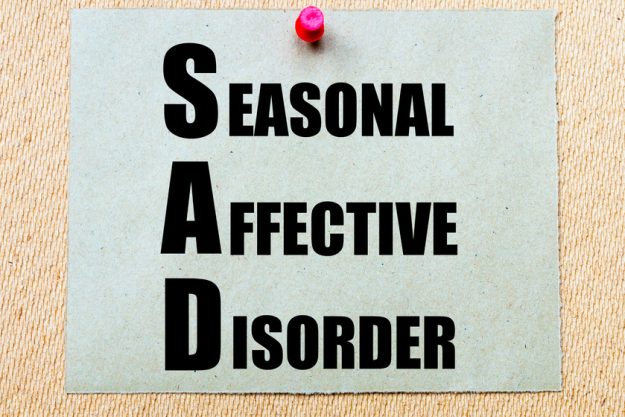 SAD as Seasonal Affective Disorder written on paper note Tips For Helping Your Loved One Manage Seasonal Affective Disorder (SAD)