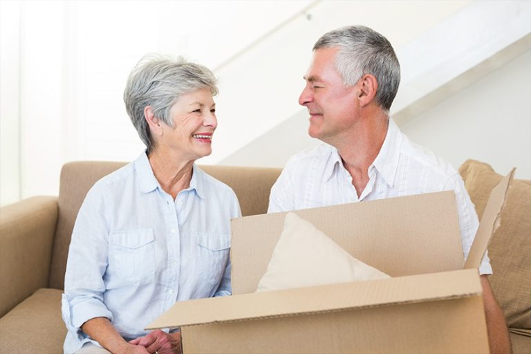 Cheerful senior couple moving into new home