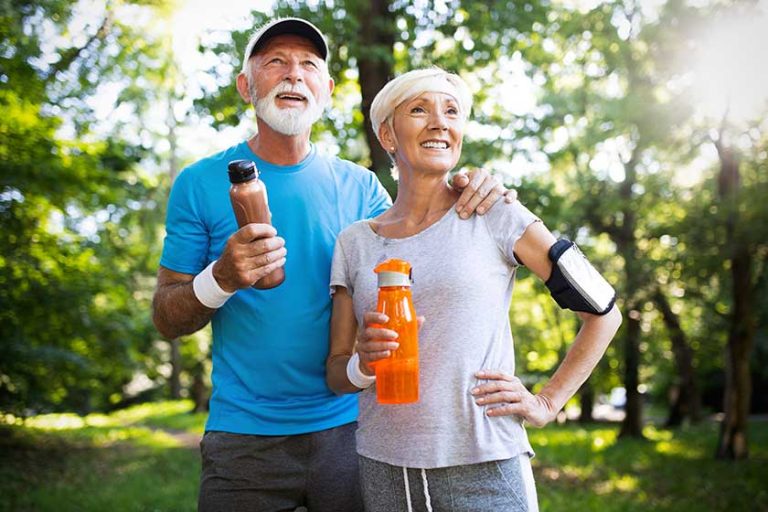 Active mature couple running in the park for helathy life Active mature couple running in the park for helathy life