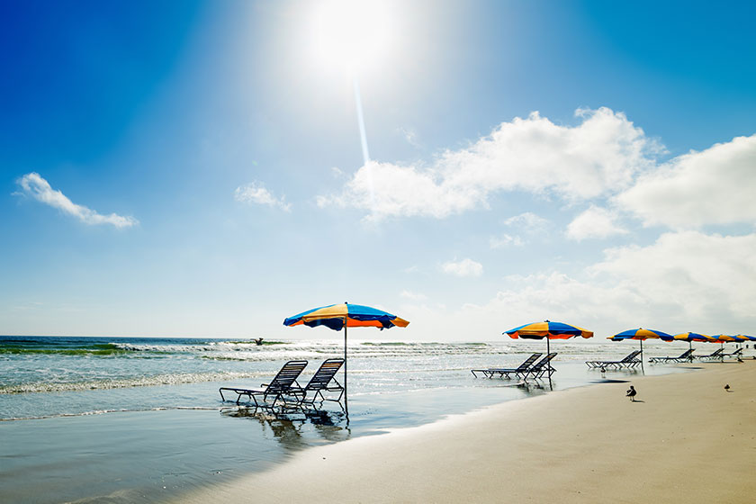 Beach chairs and parasols in Daytona Beach under a shining sun