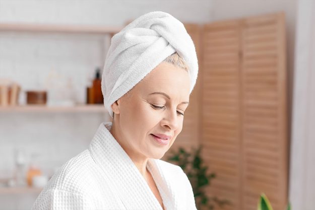 Beautiful mature woman with towel in bathroom Beautiful mature woman with towel in bathroom