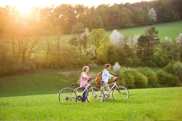 Beautiful senior couple with bicycles outside Beautiful senior couple with bicycles outside