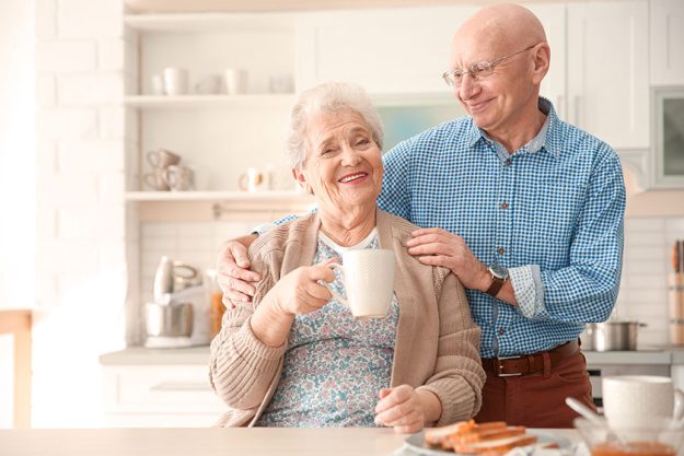 Elderly couple having breakfast in kitchen Elderly couple having breakfast in kitchen