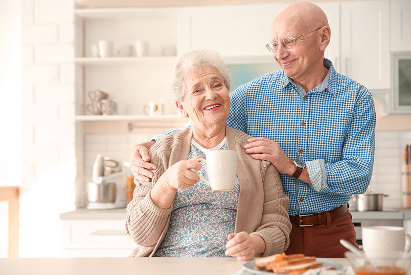 Elderly couple having breakfast in kitchen Elderly couple having breakfast in kitchen