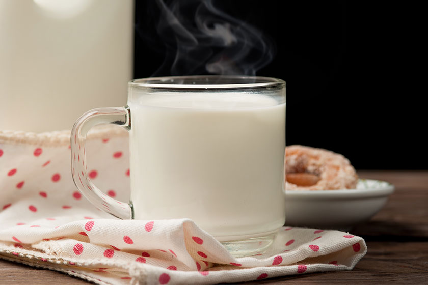 Glass of milk with doughnut on wood Glass of milk with doughnut on wood