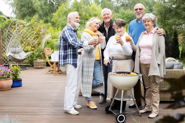 Group of happy senior people during garden party