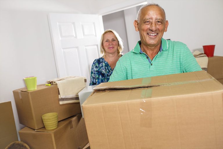 Happy senior couple moving into their new home. Happy senior couple moving into their new home.