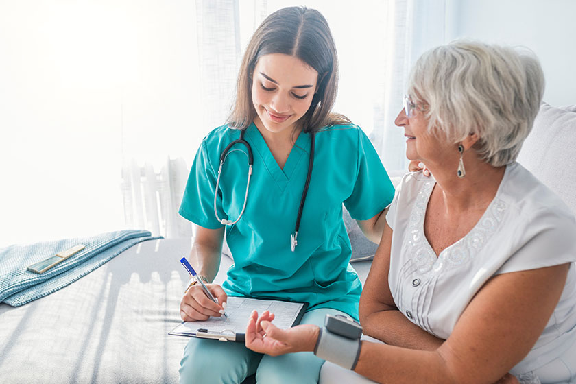 Nurse measuring blood pressure of senior woman at home Nurse measuring blood pressure of senior woman at home
