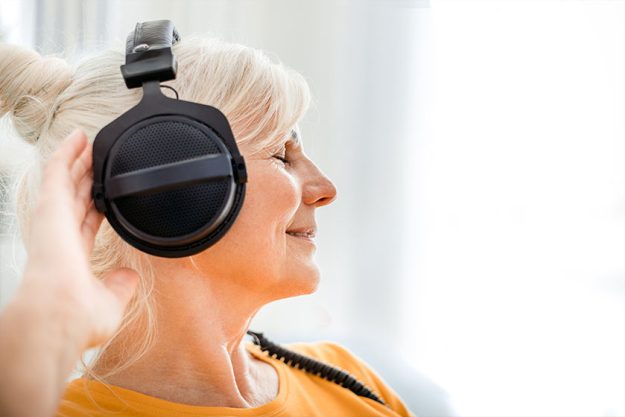 Relaxed senior woman listening her favourite music Relaxed senior woman listening her favourite music