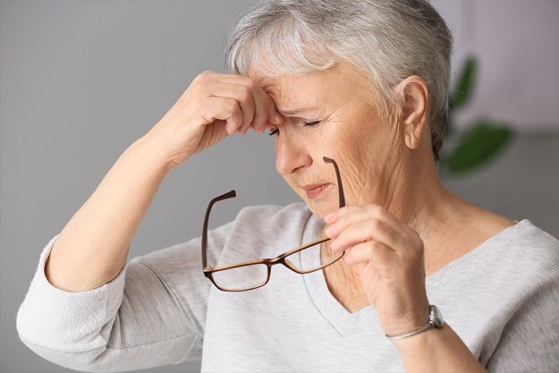 Senior woman suffering from headache at home Senior woman suffering from headache at home