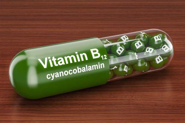 Vitamin capsule B12 on the wooden table. 3D rendering