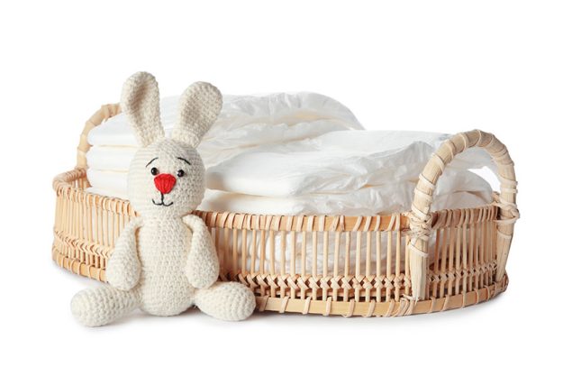 Wicker tray with disposable diapers and toy bunny Wicker tray with disposable diapers and toy bunny