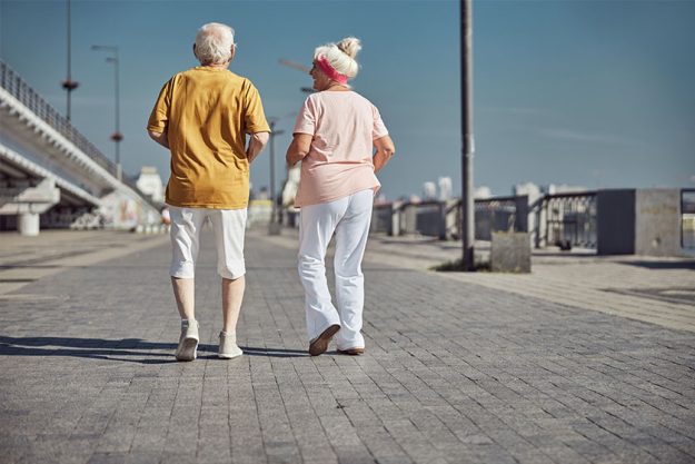 Woman and her husband speed walking together