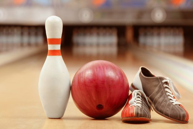 Shoes, pin and ball on floor in bowling club Shoes, pin and ball on floor in bowling club