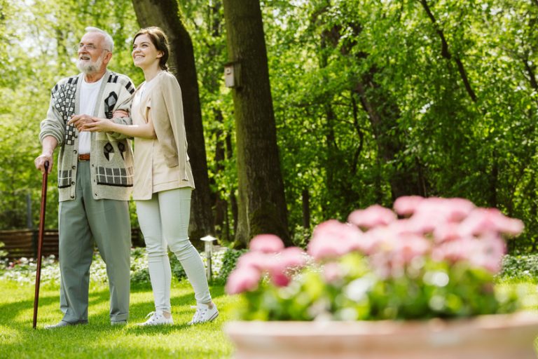 Garden of the nursing home and nurse with patient Garden of the nursing home and nurse with patient