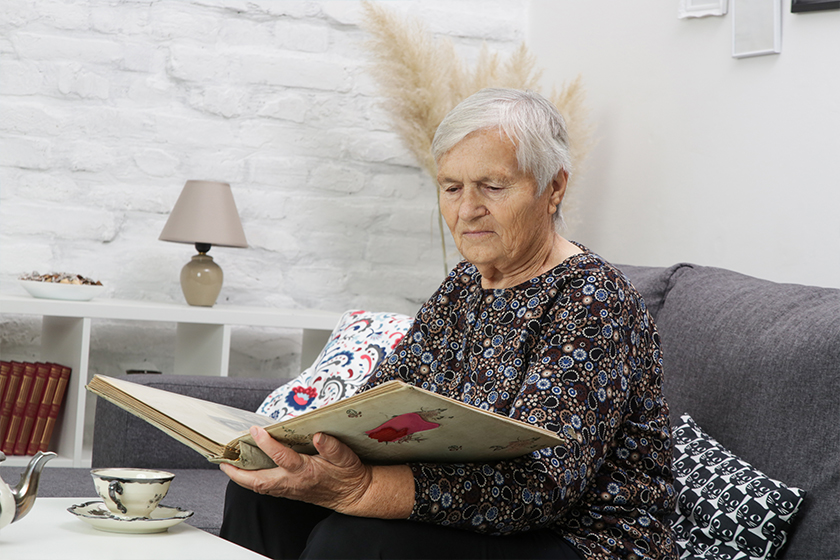 Grandmother looking at family photo album Grandmother looking at family photo album