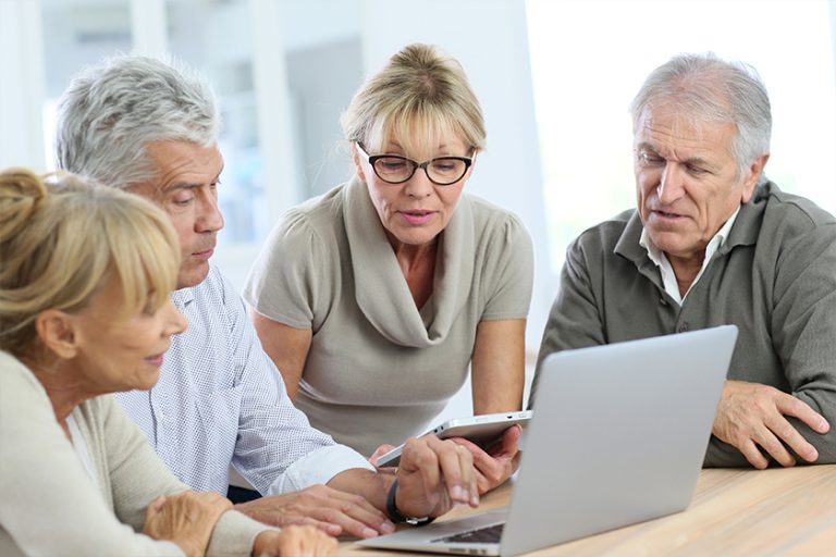 Group of retired senior people using laptop and tablet Group of retired senior people using laptop and tablet