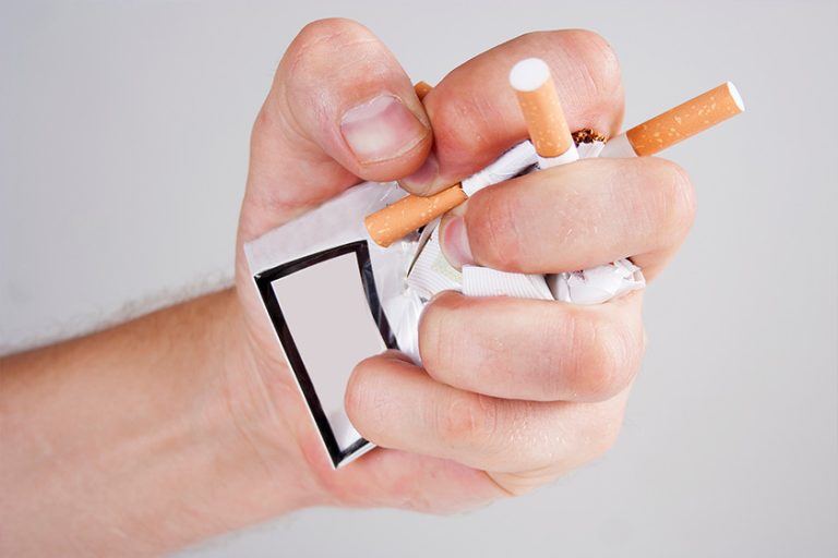 Hand crushing cigarettes
