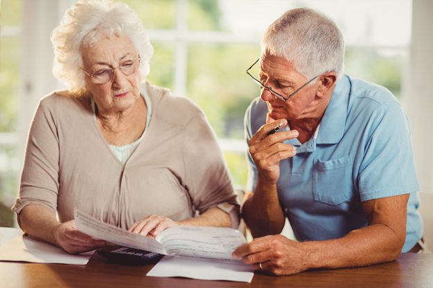 Senior couple counting bills