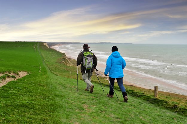 senior couple walking along the opal coast senior couple walking along the opal coast