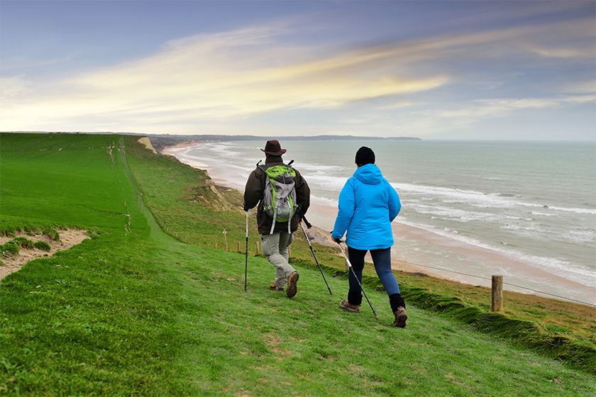 senior couple walking along the opal coast senior couple walking along the opal coast